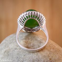 A stunning translucent large oval green nephrite jade ring. The jade is set in a double diamond halo setting in solid 18KT white gold. The jade is about 12x16mm and is approx. 11.45 carats. The total weight of the brilliant cut round white diamonds is 0.46 carats. The band is 2 - 3mm. This is a significant size ring! This ring would make a statement and is a lovely cocktail ring or engagement ring. Dimensions: Natural untreated AAA gem grade Nephrite Jade: 11.45 carats Origin - Siberia Color: Br Green Oval Dome Ring For Formal Occasions, Elegant Green Dome Ring With Polished Finish, Elegant Green Dome Ring, Green Oval Gemstone Dome Ring, Jade Rings With Polished Finish In Oval Cabochon Shape, Jade Oval Cabochon Rings With Polished Finish, Green Oval Cabochon Dome Ring, Jade Rings With Polished Finish, Oval Cabochon, Oval Cabochon Jade Rings With Polished Finish