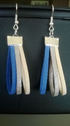 two pairs of earrings with blue and white strips hanging from the end of each pair