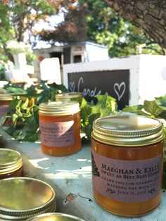 jars of marghan and kellier tea sit on a table in the shade