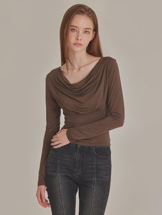 This sophisticated long-sleeve top features a cowl neck design with elegant draping details and a flattering slim waistline silhouette. The luxurious rayon-spandex blend offers a subtle sheen and smooth texture, while maintaining excellent elasticity and comfort. A unique tone-on-tone embroidery detail at the back neck adds a distinctive touch to this Korean-made piece, making it perfect for both casual and dressy occasions.Country of Origin: KOREA Sheer Wrap Top, Draped Tops, Draping Blouse, Drape Top, Dramatic Style, Fall Fit, Draped Top, Cowl Neck Long Sleeve, Slim Fit Top