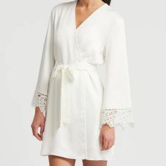 Anthropologie Rya Collection Rosey Cover Up In Ivory Satin. Short Style Robe With Side Pockets. Ties At Waist. Lace Trimmed Sleeves. New With Tag. Underarm To Underarm Measured Flat Across The Back Is 20" And Stretches To 22". Hip To Hip Measured Flat Across The Back Is 24" And Stretches To 26". Length Is 34" Measuring From Neckline To Hem At The Back. 100% Polyester. Smoke Free, Pet Free Home. Chic V-neck Sleepwear For Wedding Night, Elegant Long Sleeve Lace Sleepwear, Chic Sleepwear With Lace Trim, Elegant Beige Sleepwear For Wedding Night, Elegant Cream Sleepwear For Loungewear, Cream Elegant Sleep Dress, Elegant Long Sleeve Cream Sleepwear, White Lace Long Sleeve Sleepwear, Elegant Beige Sleepwear For Summer