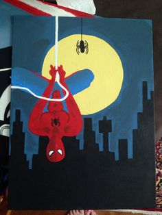 a painting of a spiderman hanging from a string in front of a cityscape