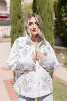 The stunning Hailey Shacket features a beautiful floral embroidered design on a crisp white background, making it a must-have this season. With its long sleeves, button down front, and large side pockets, this shacket not only adds style but also practicality to any outfit. Details + Fit 100% Polyester Runs True to Size Hand Wash Cold Hang Dry Collared Neckline Long Sleeves Button Down Front Large Side Pockets Quilted Floral Embroidered Design White | Multi | Printed Model is 5'6" and wearing a size Small Winter White Outerwear With Floral Embroidery, White Floral Print Winter Outerwear, White Floral Embroidered Winter Outerwear, Quilted Shacket, Multicolor Embroidered Floral Print Long Sleeve Outerwear, Floral Embroidered Cotton Button-up Outerwear, Embroidered Quilts, Embroidered Design, Outfit Details