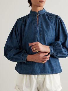 SUZIE KONDI Kaprico gathered denim blouse | NET-A-PORTER Relaxed Fit Denim Blouse, Denim Blue Cotton Blouse In Relaxed Fit, Denim Blue Cotton Relaxed Fit Blouse, Denim Blue Relaxed Fit Cotton Blouse, Washed Blue Cotton Blouse Relaxed Fit, Denim Blue Blouse For Work, Washed Blue Cotton Blouse, Relaxed Fit, Washed Blue Cotton Blouse With Relaxed Fit, Light Indigo Long Sleeve Tops For Work