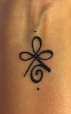 a black tattoo on the back of a woman's neck with an infinite symbol