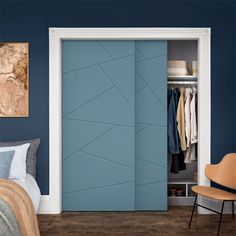 a bedroom with blue walls and an open closet door that has clothes on hangers