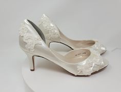 "Lace Wedding shoes.  Ivory bridal shoes that can also be dyed in over 100 additional colors, as well as matching a sample you provide.  .  They are embellished with delicate lace.  The shoe in this listing has a 3 inch heel, but is also available in heel size 2 inch. DYE COLORS: My goal is for you to have your shoes dyed the exact color you want.  Please understand that all computer monitors/phone screens are set to different settings which could make the color of the shoes you see in the listi White Open Toe Court Shoes For Wedding, Fitted Open Toe Court Shoes For Wedding, White Open-toe Court Shoes For Wedding, White Almond Toe Wedding Court Shoes, Fitted Almond Toe Court Shoes For Wedding, Fitted Almond Toe Wedding Court Shoes, Fitted Almond Toe Wedding Shoes, Cream Closed Toe Court Shoes For Wedding, Cream Round Toe Wedding Shoes