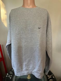 True vintage Nike small side swoosh crewneck sweatshirt from the 90's. Athletic grey size XL crewneck in excellent shape, no holes or stains. Measures 26.5" pit to pit, 28" shoulder to bottom. Vintage Grey Nike Sweatshirt, Sweat Vintage, Nike Vintage, Vintage Nike, True Vintage, Cleveland, Crewneck Sweatshirt, Sweat Shirt, Gender Neutral