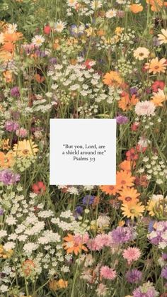 a field full of wildflowers with a quote on the front saying that your lord is a shield around me forever