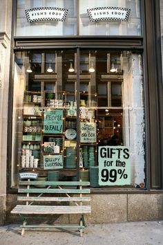 a store front with a sign that says gifts for the 99 % off on it