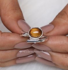 Tiger Eye Ring, 925 Sterling Silver Ring, Oval Gemstone Ring, Adjustable Ring, Women Silver Ring, Handmade Jewelry, Best Friend Gift Ring Gemstone Name - Tiger's Eye  Stone Quality - AAA  Weight - 3.18 gm  Stone Shape - As shown in the picture Ring Size - All Ring Size Available  We serve complete 925 sterling silver Jewelry and genuine properties of the stone.  The products are dispatched from the small business from UK. Product Quality and Packaging - Our all products are 925 Silver Stamped which shows that the product is genuine and authentic .The products are dispatched from the small business from UK so you get the product on time and the product packaging comes in bubble foil wrap with all the precautions taken primarily that your product reaches you with zero damage. Properties of T Adjustable Oval Rings With Ethical Gemstones, Oval Sterling Silver Stackable Rings With Polished Finish, Unique Adjustable Oval Stackable Rings, Adjustable Oval Gemstone Stackable Rings, Adjustable Oval Stackable Rings With Polished Finish, Adjustable Oval Cabochon Ring For Promise, Oval Sterling Silver Stackable Rings Fine Jewelry, Oval Sterling Silver Stackable Rings, Adjustable Oval Cabochon Promise Ring