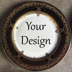 a black and gold plate with the words your design written on it, in front of a wall