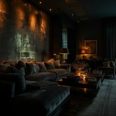 a living room with couches, lamps and paintings on the wall in it's dark color scheme