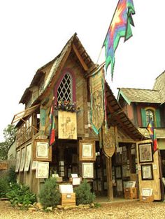 an old wooden building with flags and pictures on it