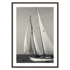 a black and white photo of a sailboat in the ocean