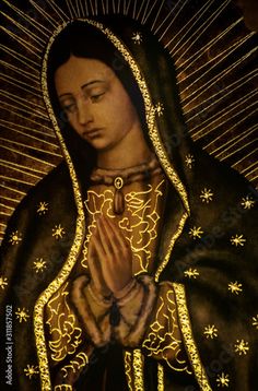 the virgin mary with her hands folded in gold sparkles, on display at an art museum