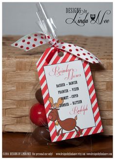 a red and white candy bar with a reindeer tag on it next to some apples