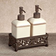 two soap dispensers sitting on top of a wooden tray