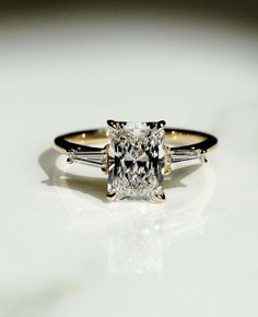 an engagement ring with three stones on it