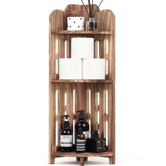 a wooden shelf with two rolls of toilet paper on it and some other items in front of it