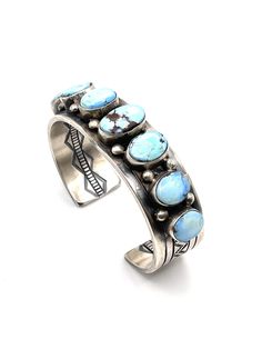 This exquisite Navajo Handcrafted Golden Hills Turquoise Cuff Bracelet, made with sterling silver and skillfully crafted by Tillie John, showcases the beauty and artistry of Native American jewelry. Adorned with a stunning golden Hills Turquoise, this bracelet is a timeless piece that will add elegance and sophistication to any outfit.  Measures 6'' end to end with an 1'' opening cuff its about 1'' wide, weights about 109 grams of sterling silver, has 7 Golden Hills Turquoise stones great quality and price Traditional Turquoise Sterling Silver Cuff Bracelet, Golden Hill, Turquoise Bracelet Cuff, Native Jewelry, Turquoise Cuff, Turquoise Stones, American Jewelry, Native American Jewelry, Turquoise Jewelry