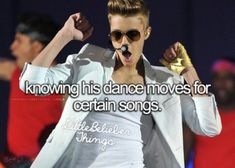 a man in white shirt and sunglasses on stage with words above him that says,'i know it is dance moves for certain songs