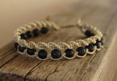 a close up of a bracelet on a wooden surface