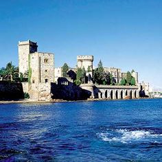 an old castle sitting on top of a large body of water