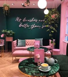 a living room filled with pink and green furniture