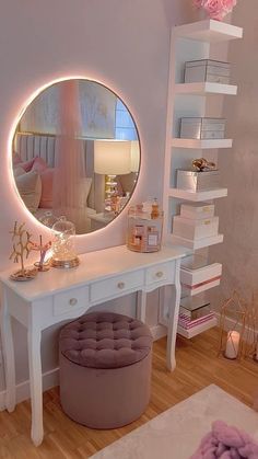 a white vanity with a round mirror and stool