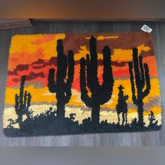 a rug with cactus silhouettes on it