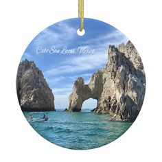 PRICES MAY VARY. Desirable & Attractive City: Brown rock formation on sea under blue sky during daytime in Mexico. Cabo is always a popular tourist city, one of the most popular destinations in the world. Material: This round ornament is made of great quality of porcelain with two sides printed. It's durable and lightweight for lasting quality and easy hanging on the family tree. Hand Crafted. Size: The beautiful city photo ornament's diameter is about 3 inches, 8cm with the gold stripe. Design: Gifts For Xmas, San Lucas Mexico, Cabo San Lucas Mexico, Photo Ornaments, Round Ornaments, Travel Souvenirs, San Lucas, Handmade Christmas Ornaments, Xmas Holidays