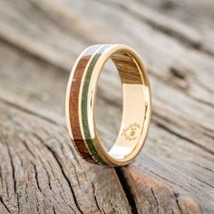 a wooden ring with two different colored wood inlays