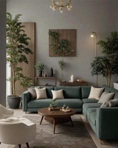 a living room with green couches and potted plants on the wall above them