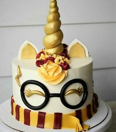 a cake decorated with glasses and a unicorn horn