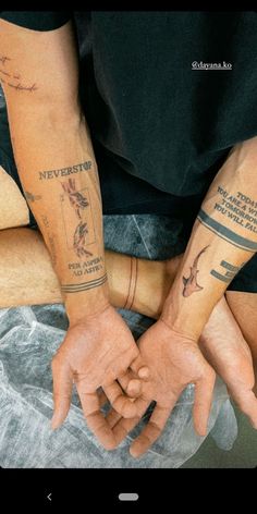 two people with matching tattoos on their arms