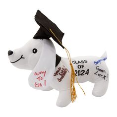 a white dog ornament with a black graduation cap on it's head