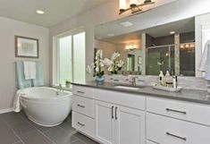 a large bathroom with two sinks and a tub