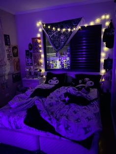 a bedroom with purple lights and black bedding in the corner is lit up by string lights