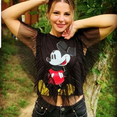 Black - 1165/635 Short Sleeve T-Shirt With A Round Neckline, Tulle Ruffle Detail And A Mickey Mouse Print. Outer Shell Main Fabric 100% Cotton Second Fabric 100% Polyester Box8/F10/11(M)11(S)Box7(S) Spring Mickey Mouse Short Sleeve Top, Black Fun Summer Tops, Fun Black Summer Tops, Mickey Mouse Short Sleeve Summer Top, Fun Mickey Mouse T-shirt, Trendy Mickey Mouse Short Sleeve Top, Mickey Mouse Crew Neck Top For Summer, Mickey Mouse Print, Disney T Shirt