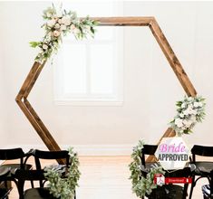 the chairs are set up with flowers and greenery on them for a wedding ceremony