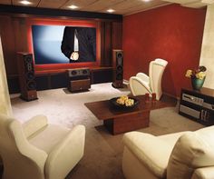 a living room filled with furniture and a flat screen tv sitting on top of a wall