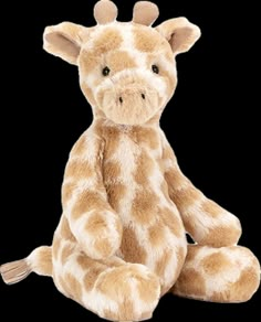 a stuffed giraffe sitting on the ground