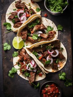 three tacos with meat, onions and cilantro on a cutting board next to salsa