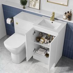 a white bathroom sink sitting under a mirror next to a toilet and bathtub with blue tiles on the walls