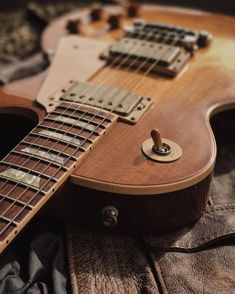 an electric guitar laying on top of a bed