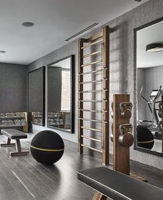 a gym with mirrors, benches and exercise balls on the floor next to each other