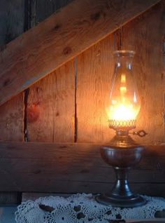 a light that is on top of a table next to a doily and other items