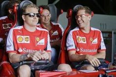 three men in red and white shirts are sitting on some seats