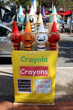 a sign that says crayons on it with pumpkins and witches in the background